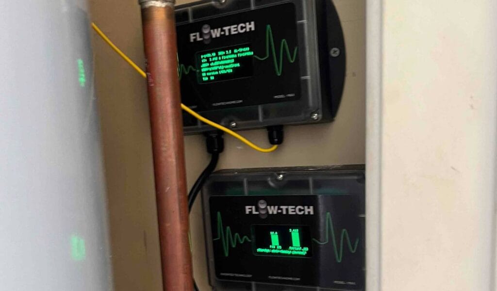 Two flow-tech home descaling devices installed in closet next to water heater