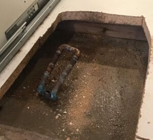 flooring cut open and deeply flooded beneath due to slab leak