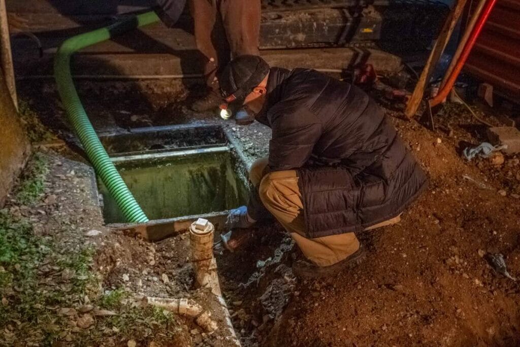 plumber inspecting commercial grease trap