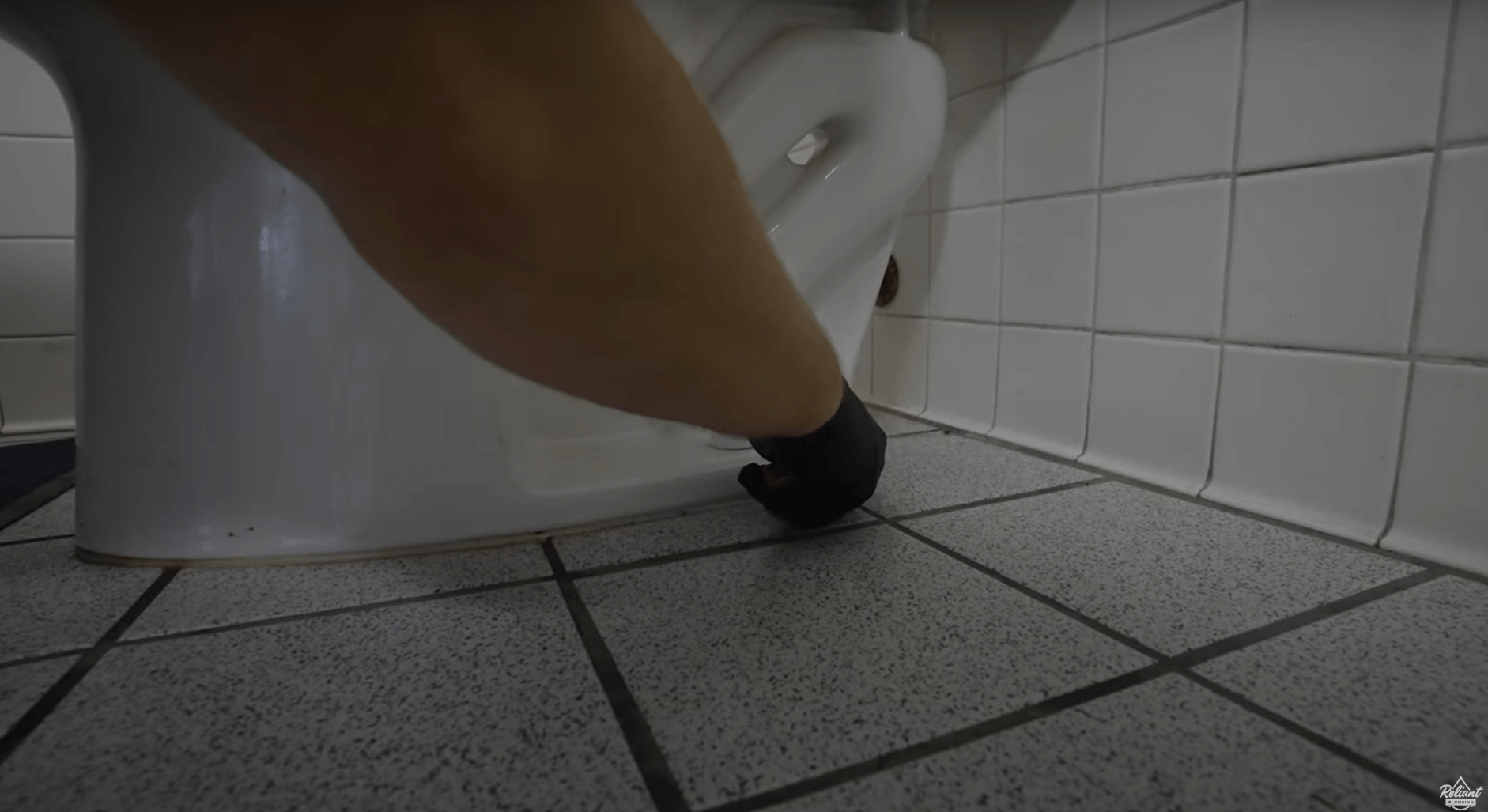 cutting tub sealant around the base of a toilet