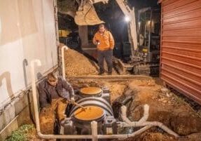 team of plumbers working on a grease trap