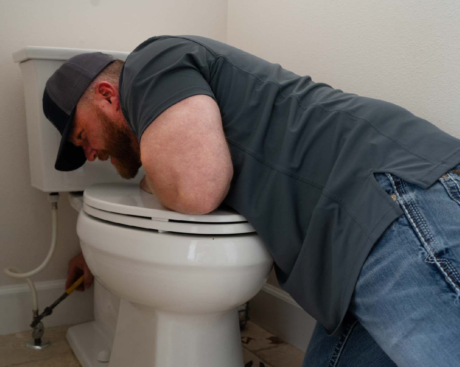 https://www.reliantplumbing.com/wp-content/uploads/2023/09/Local-Austin-Plumber-fixing-toilet-BEST.jpg